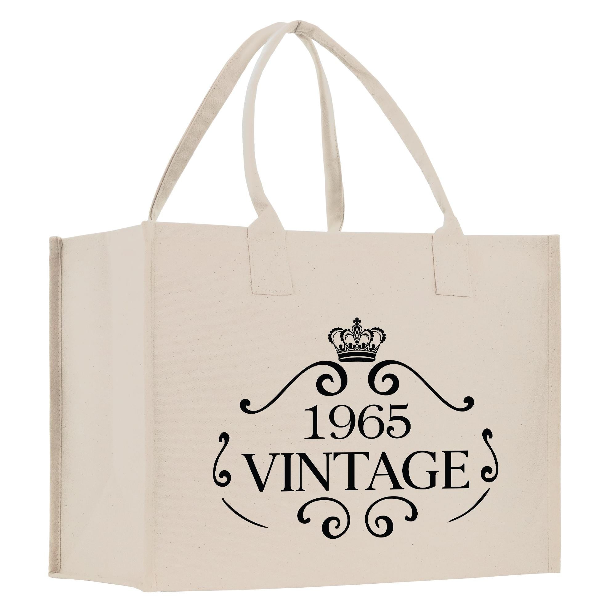 A beige canvas tote bag with a black text design that reads "1965 VINTAGE".