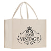 A beige canvas tote bag with a black text design that reads 