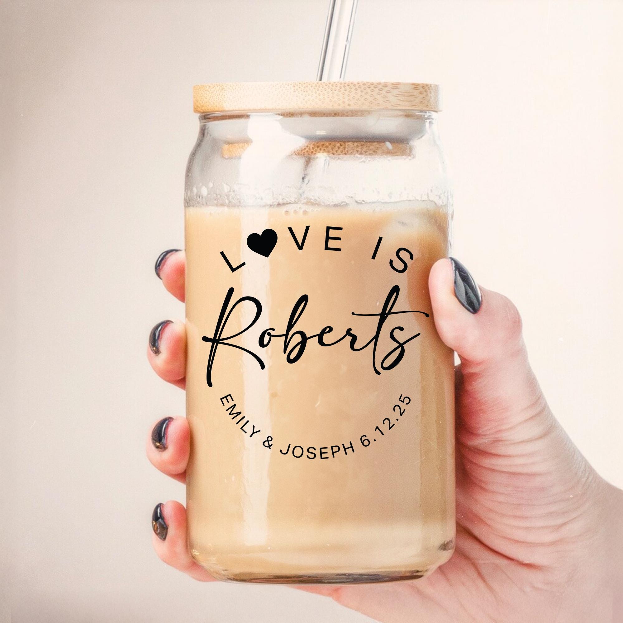 a woman holding a mason jar with a drink in it