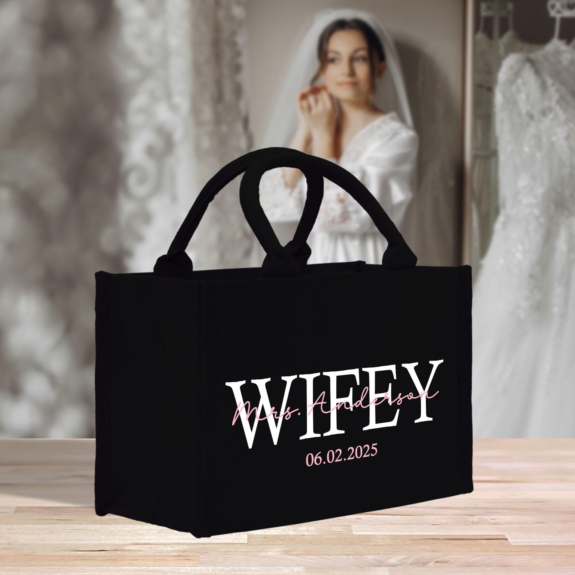 a black bag sitting on top of a wooden table