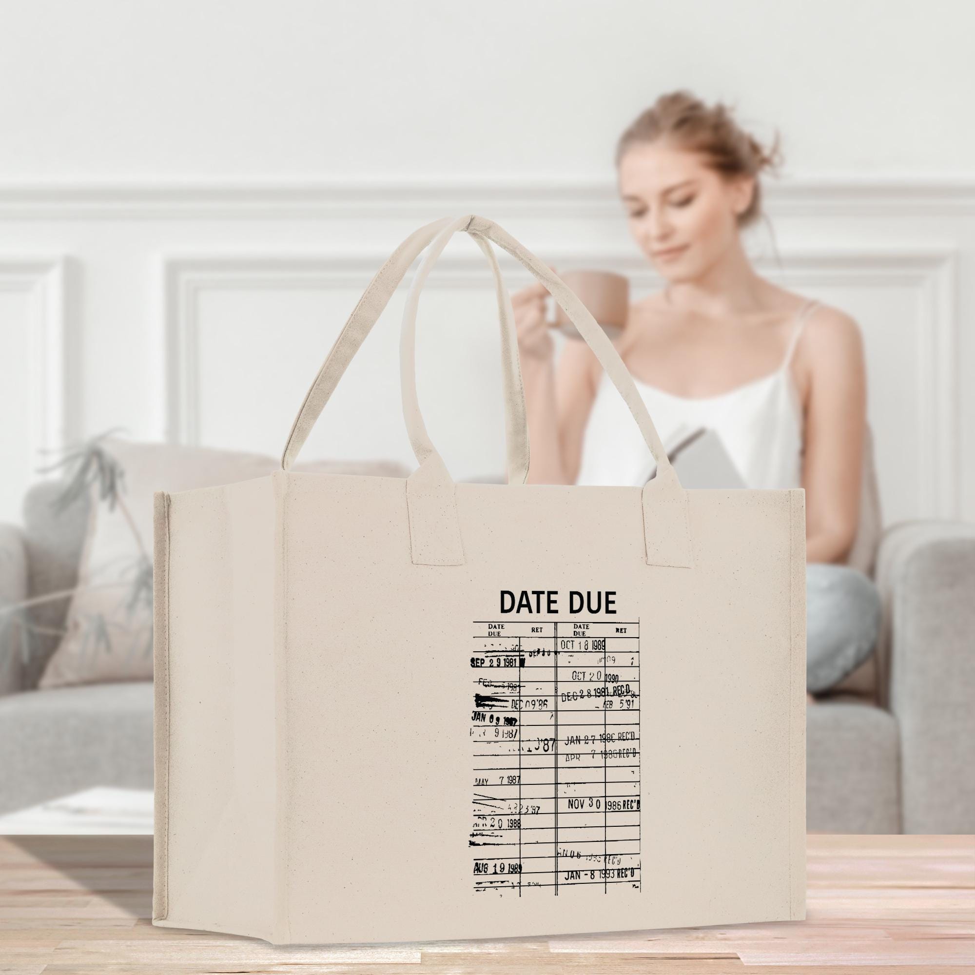 a woman sitting on a couch with a bag in front of her
