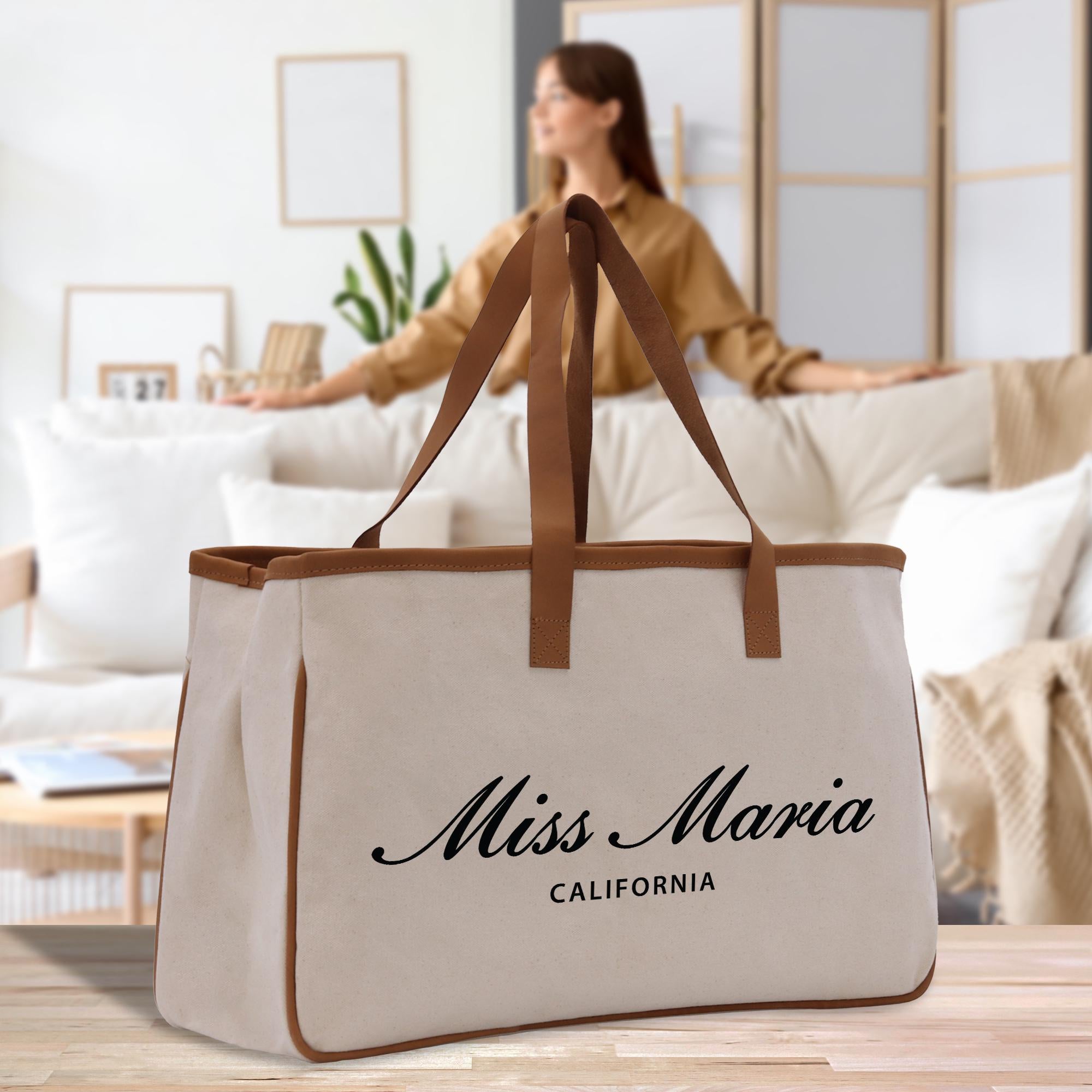 a woman sitting on a couch with a large bag