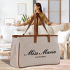 a woman sitting on a couch with a large bag