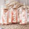 Three glass jars with straws, each labeled with a different word: 'Bride', 'babe', and 'Mrs.'