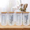 three personalized water bottles with straws on a table