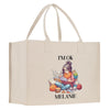 a bag with a picture of a girl reading a book