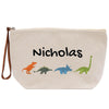 A beige canvas tote bag with the name "Nikolas" printed on it, along with illustrations of four different dinosaurs in various colors.