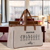 A beige canvas tote bag with a printed design of flowers and the text "GOD SAYS YOU ARE Ashley" printed on it, placed on a wooden surface in a room with a window.