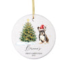 a ceramic ornament with a dog and a christmas tree