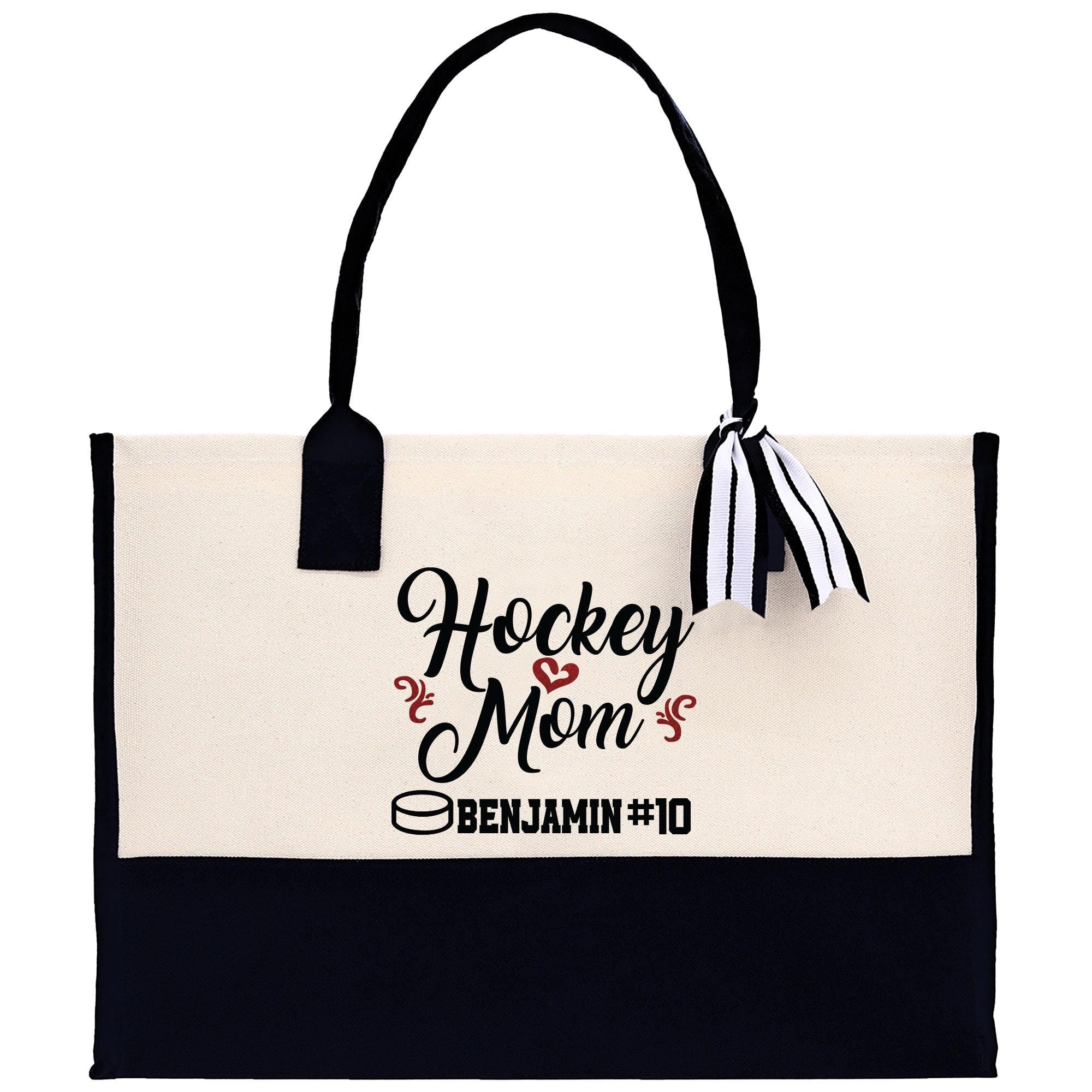 a black and white tote bag with hockey mom on it