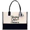 a black and white tote bag with hockey mom on it