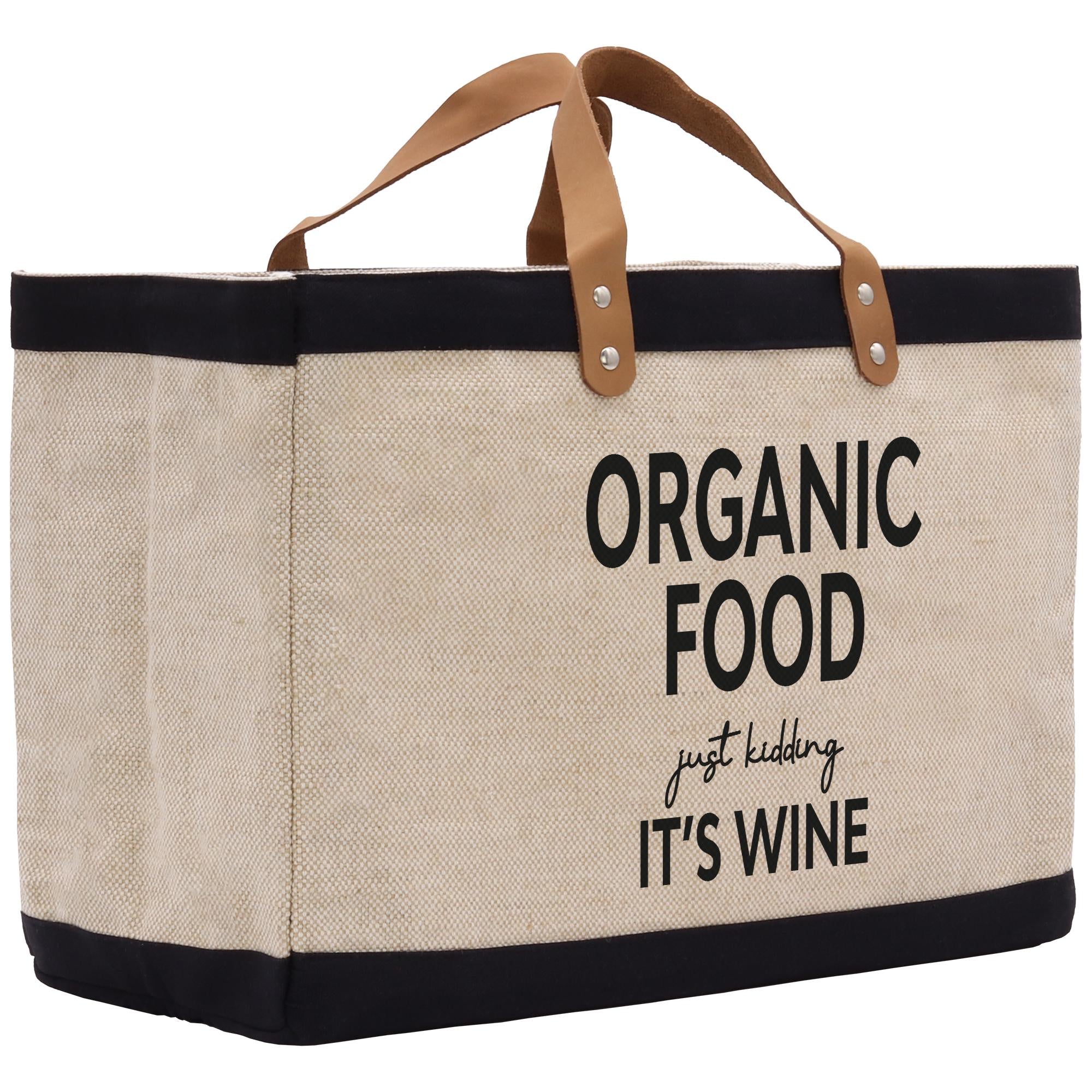 A beige canvas tote bag with black trim and leather handles, featuring the text &quot;ORGANIC FOOD just kidding IT&#39;S WINE&quot; printed on it.
