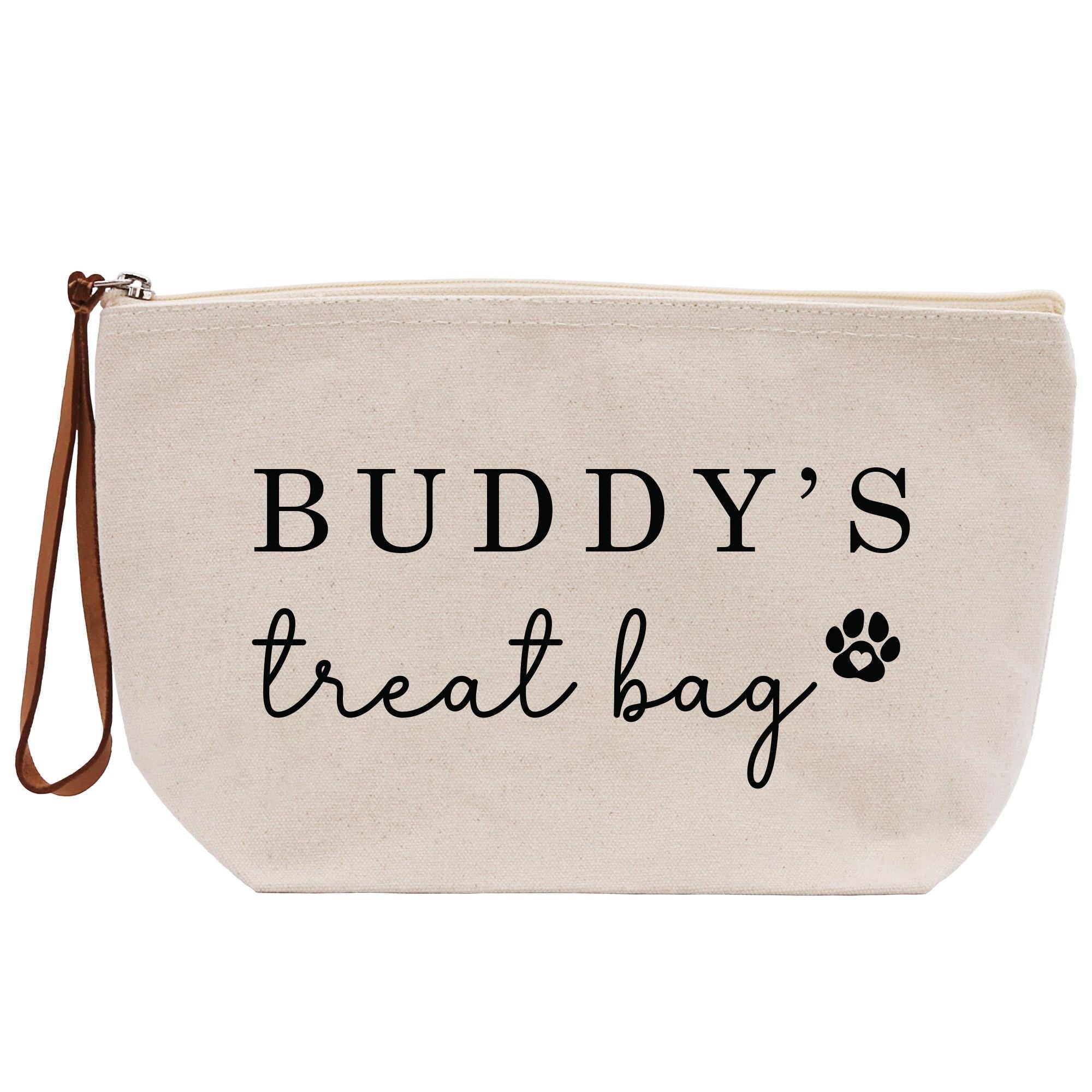 A beige canvas bag with the text &quot;BUDDY&#39;S TREAT BAG&quot; printed on it.