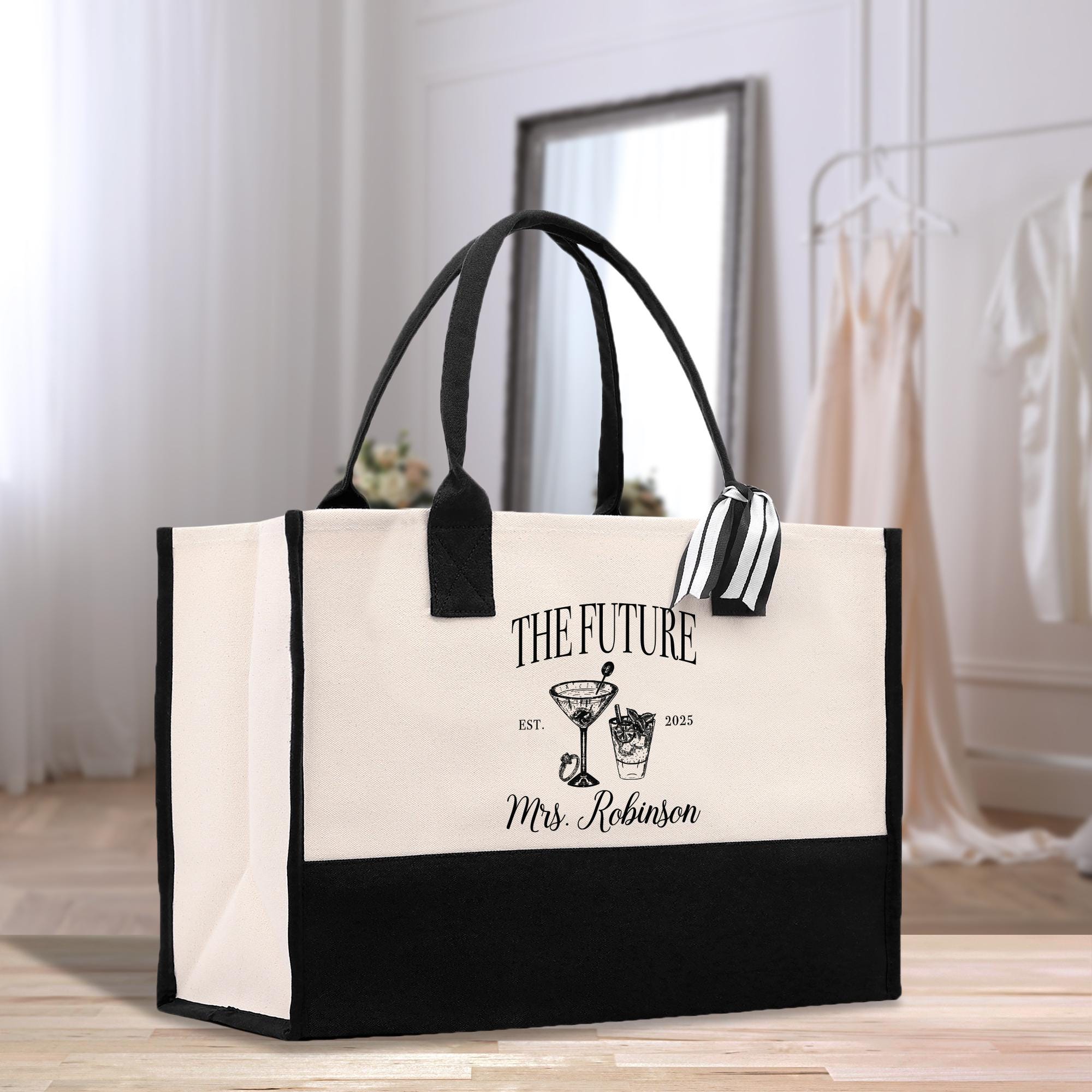 a black and white bag sitting on top of a wooden floor