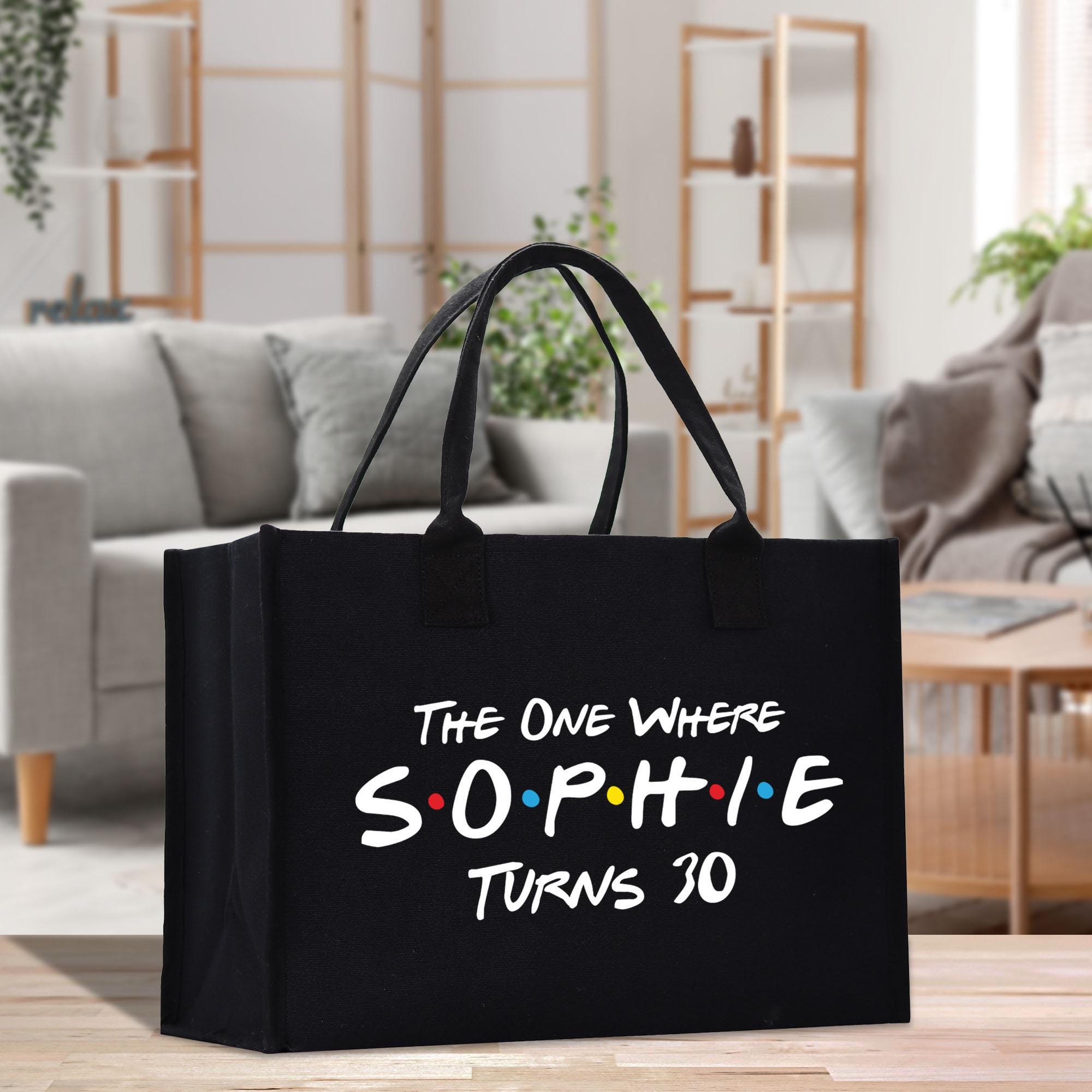 a black shopping bag that says the one where someone turns 30