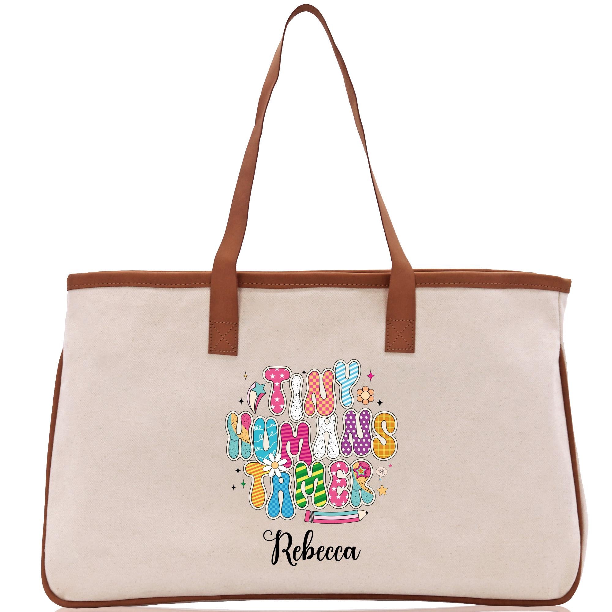 A beige canvas tote bag with a personalized name printed on it.