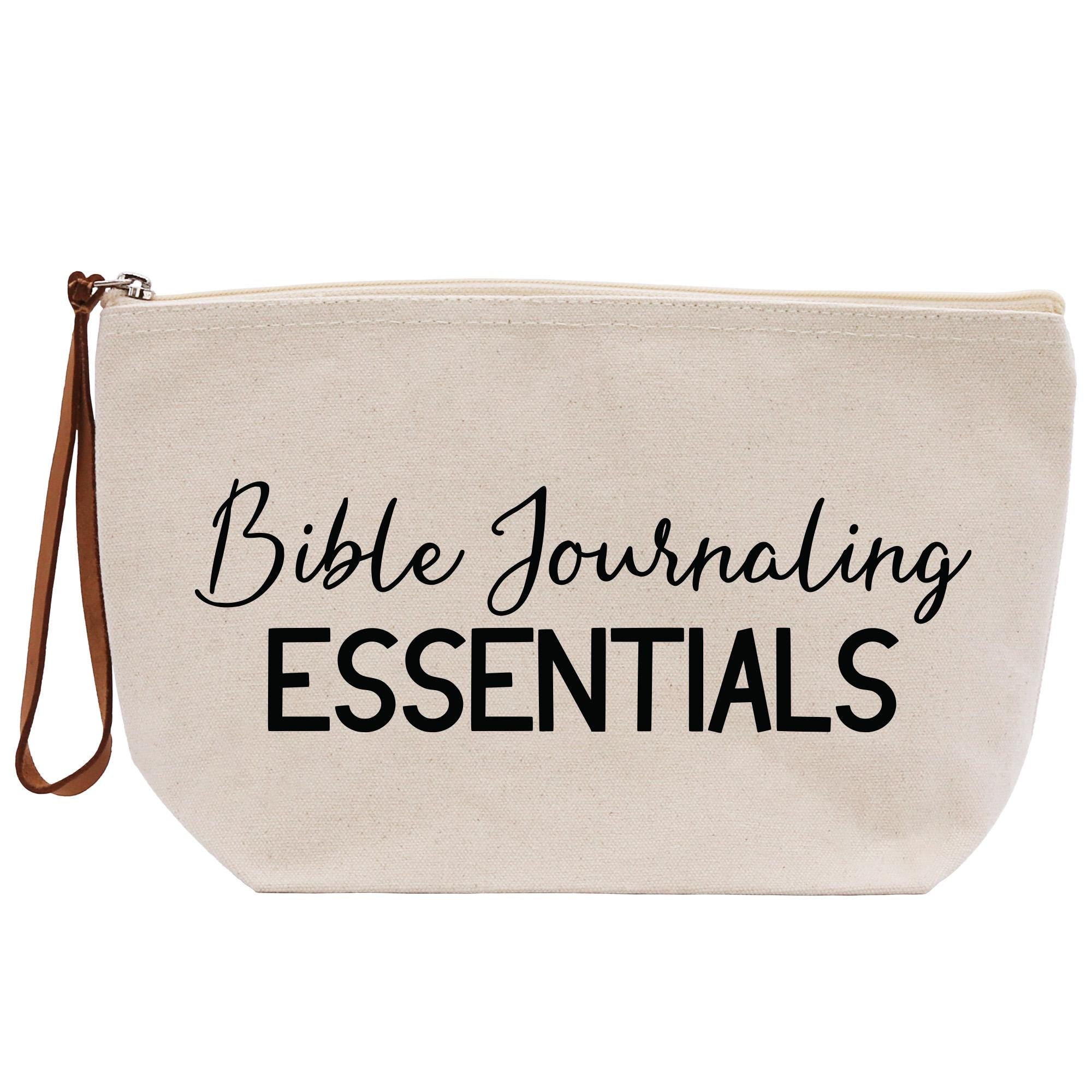 a white bag with the words bible journaling essentials printed on it