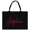 a black tote bag with a red name on it