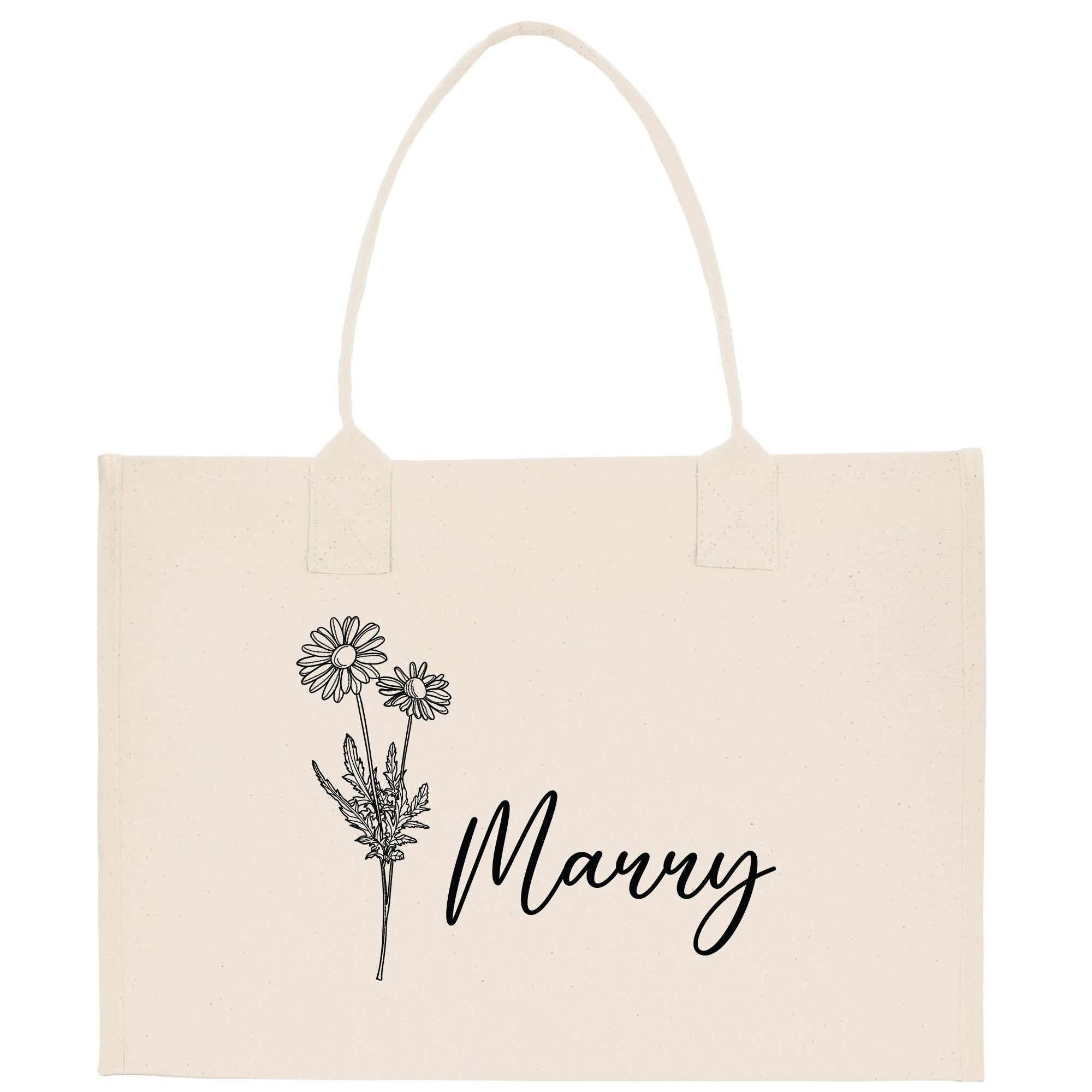 A beige canvas tote bag with a floral design and the word &quot;Manny&quot; printed on it.