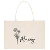 A beige canvas tote bag with a floral design and the word "Manny" printed on it.