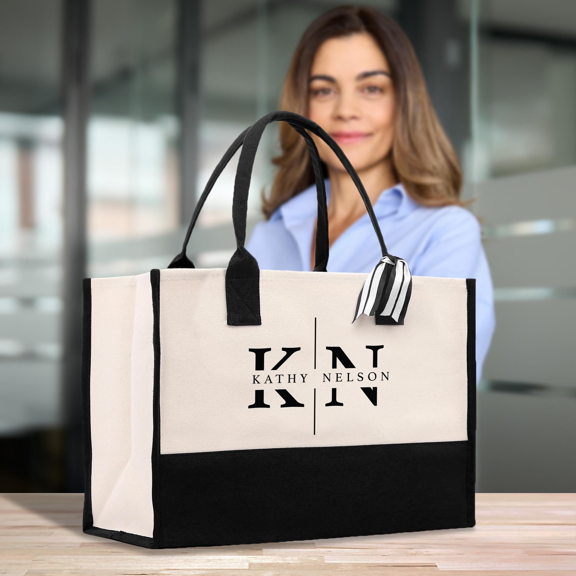 A woman is standing behind a large tote bag with the name &#39;Kathy Nelson&#39; printed on it.