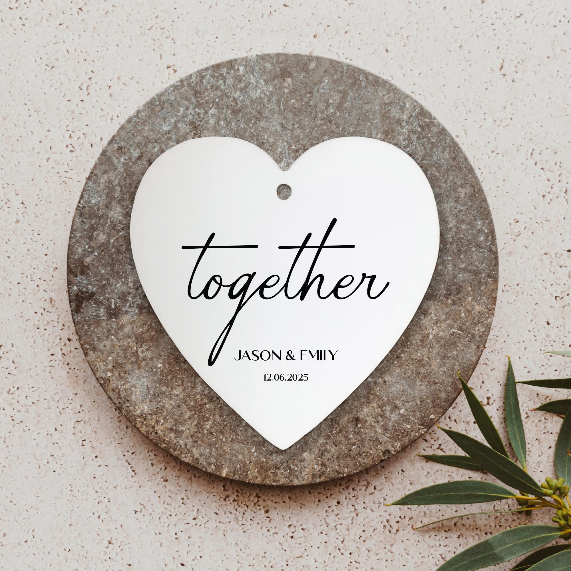 a heart shaped plaque with the words together on it