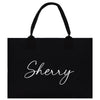 a black shopping bag with the word sheryl printed on it