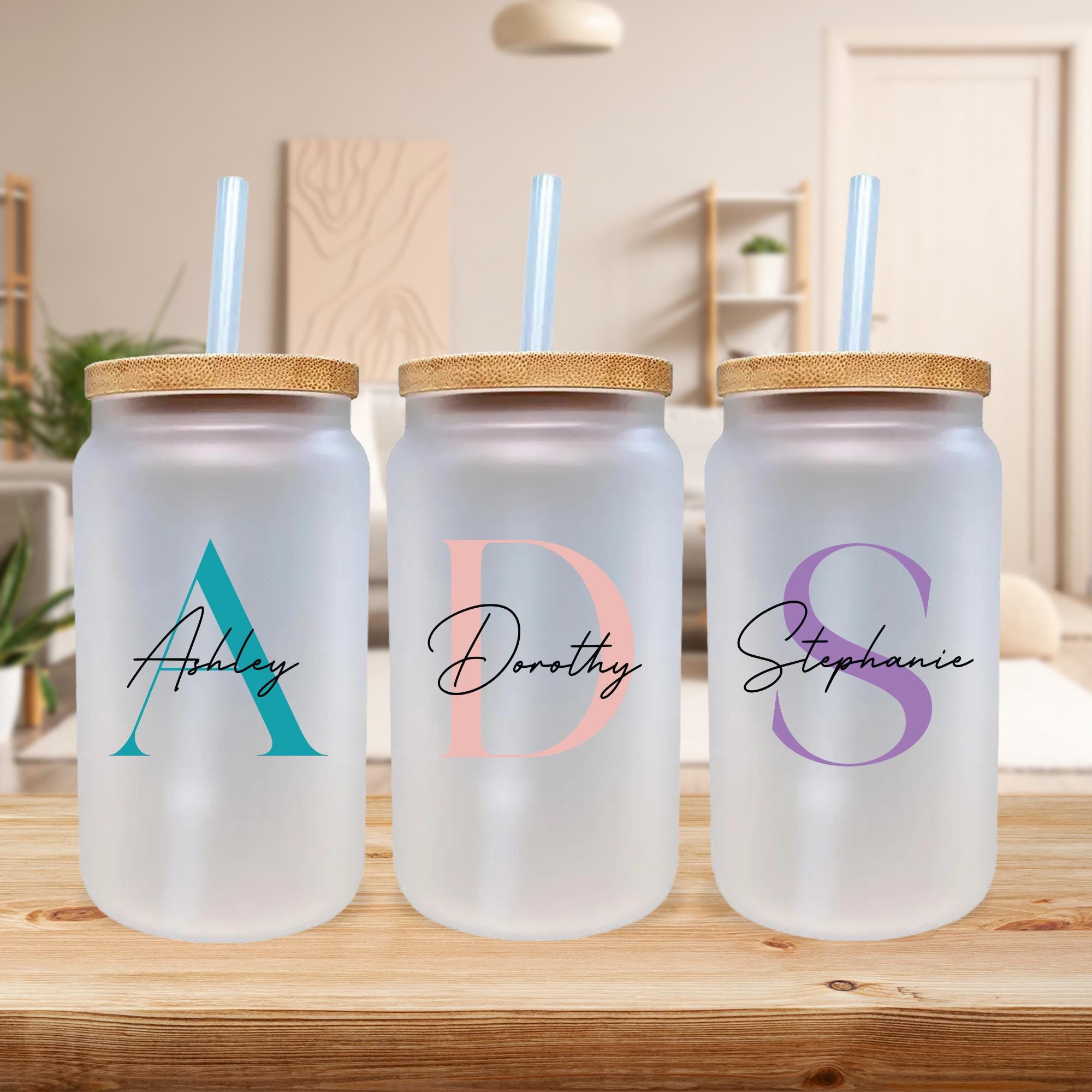 three personalized water bottles sitting on a table