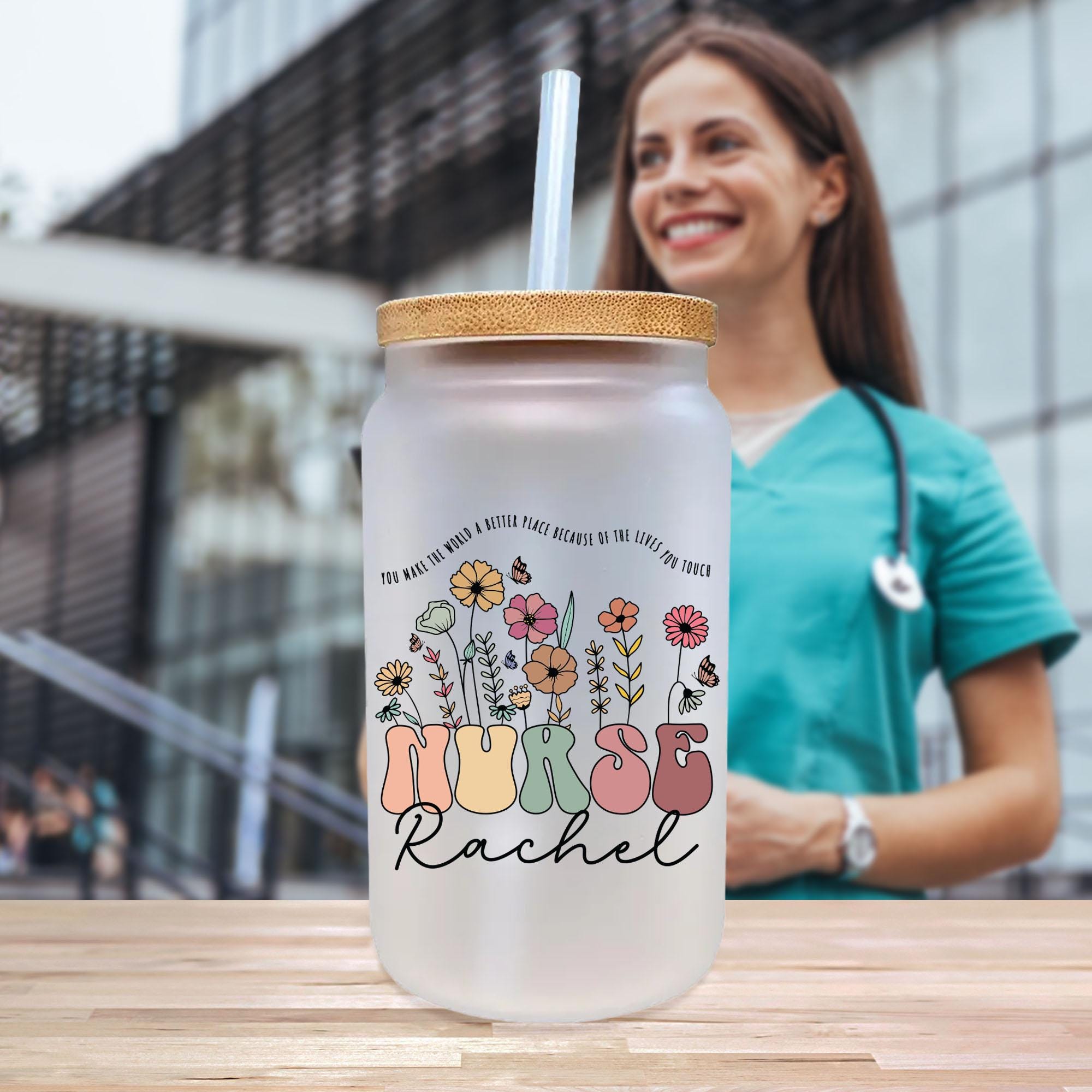 a woman standing next to a glass with a straw in it