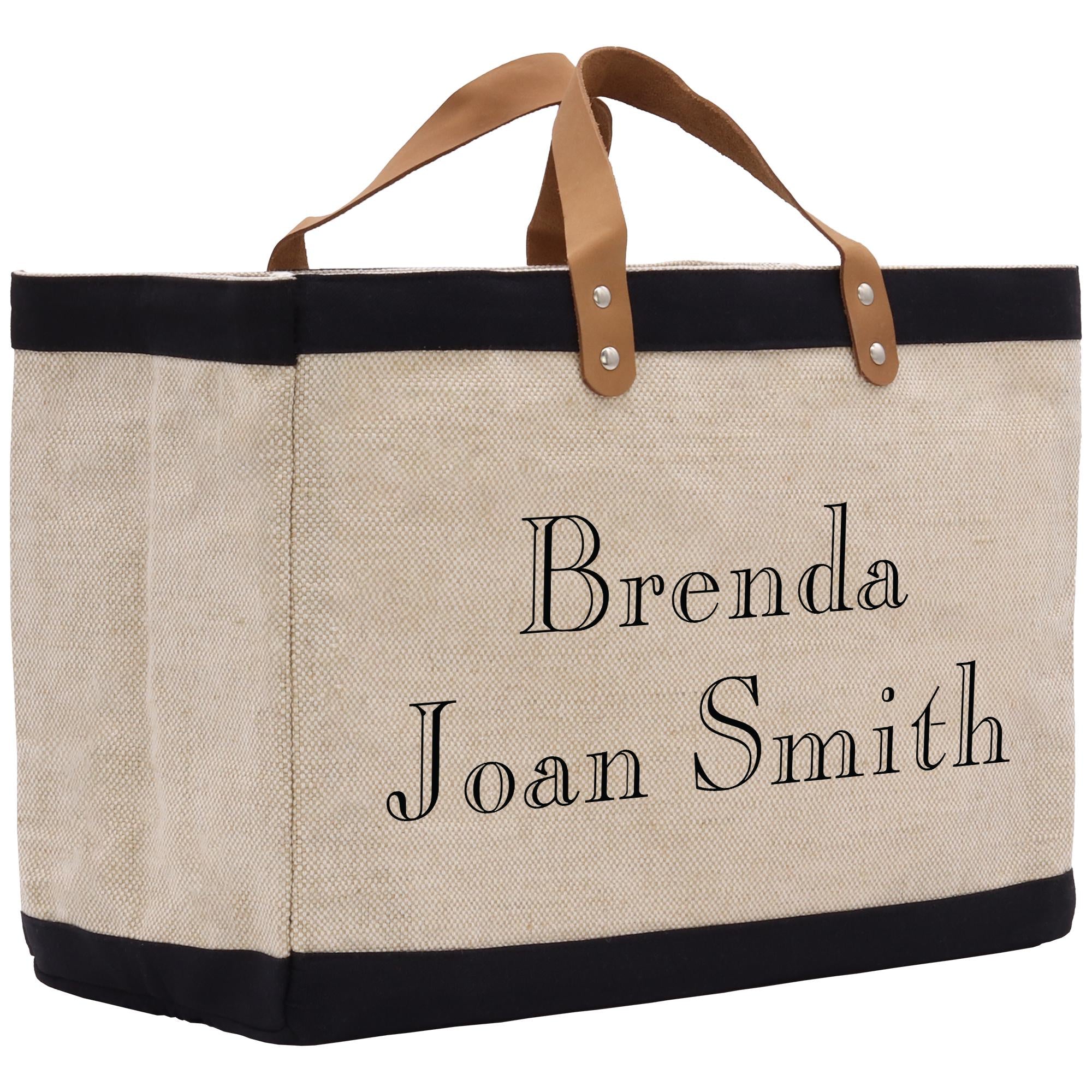 A beige tote bag with black trim and leather handles, featuring personalized text that says &quot;Benda Joan Smith&quot;.