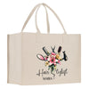 a shopping bag with scissors and flowers on it