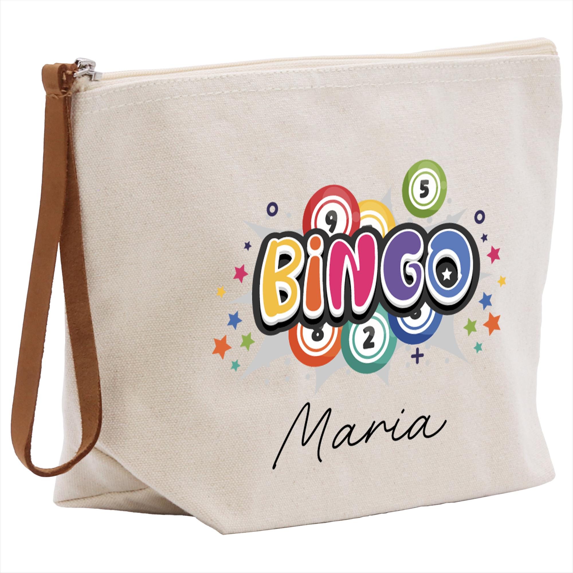 A beige canvas tote bag with a colorful graphic design featuring the word &quot;BINGO&quot; surrounded by stars and numbers.