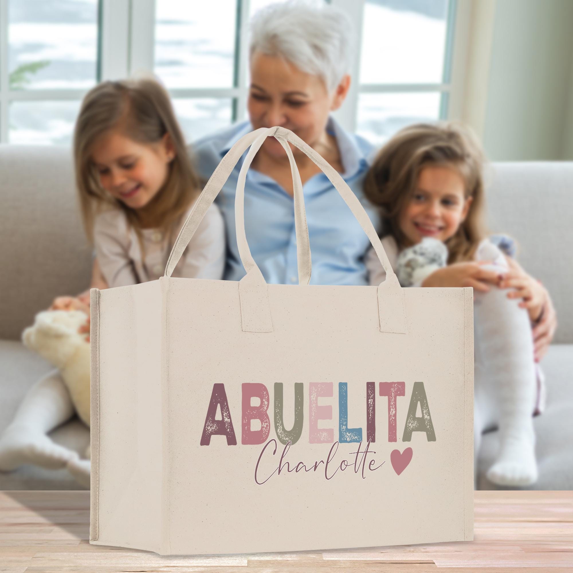 a woman and two girls sitting on a couch with a bag