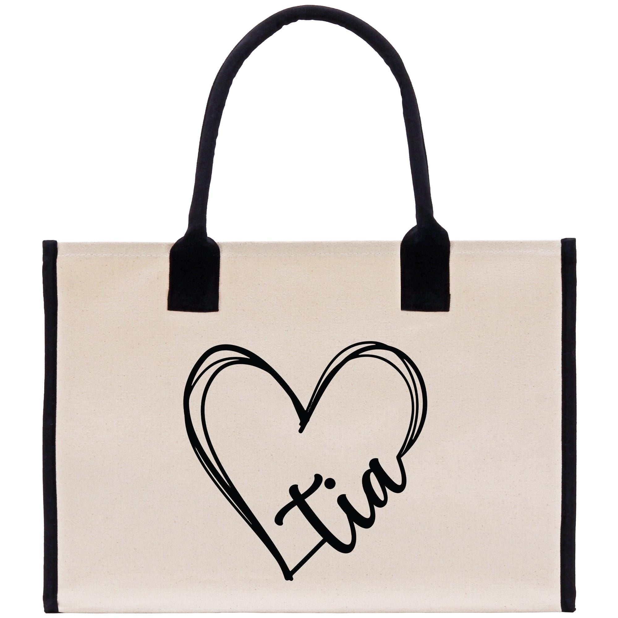 a canvas bag with a heart and initials on it