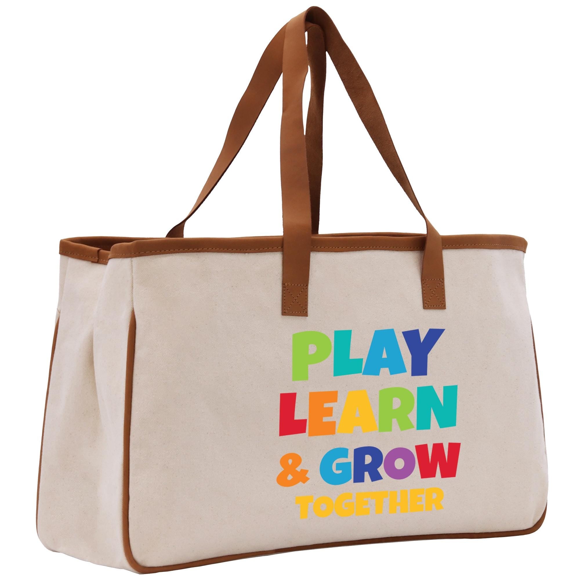 a canvas tote bag with a play learn and grow message