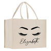 a white shopping bag with eyelashes on it