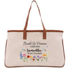 a beige tote bag with a floral design and text printed on it.