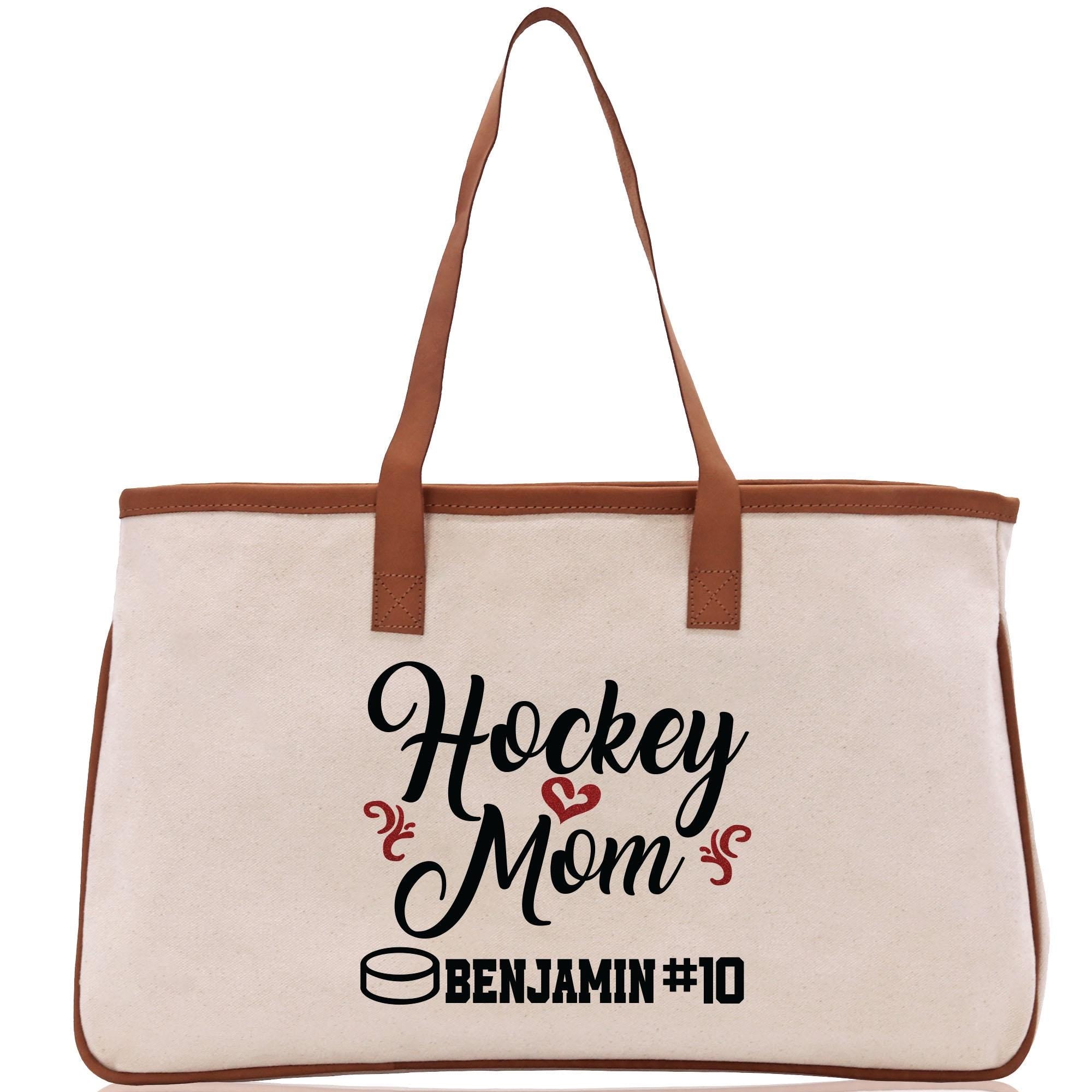 a canvas tote bag with the words hockey mom on it