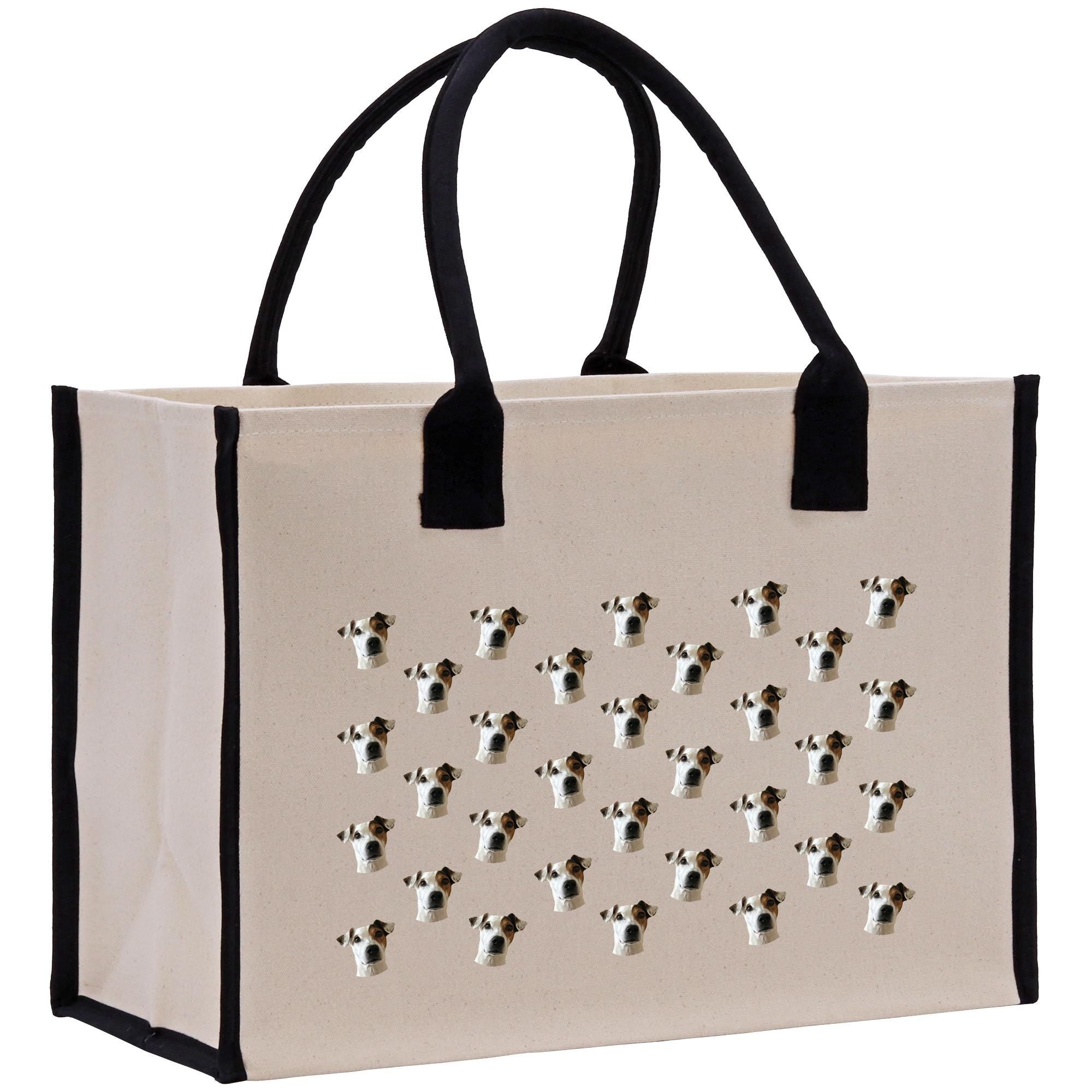 A beige canvas tote bag with black handles and straps, decorated with a repeating pattern of dog faces.