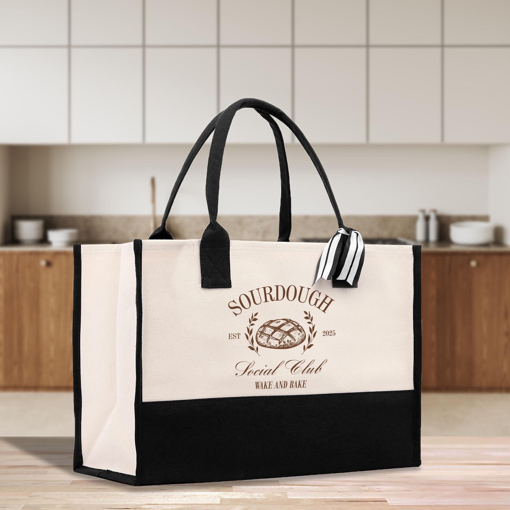 a black and white shopping bag sitting on top of a wooden table