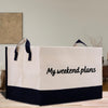 a white and black shopping bag with the words my weekend plans printed on it