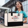 a woman holding a black and white shopping bag