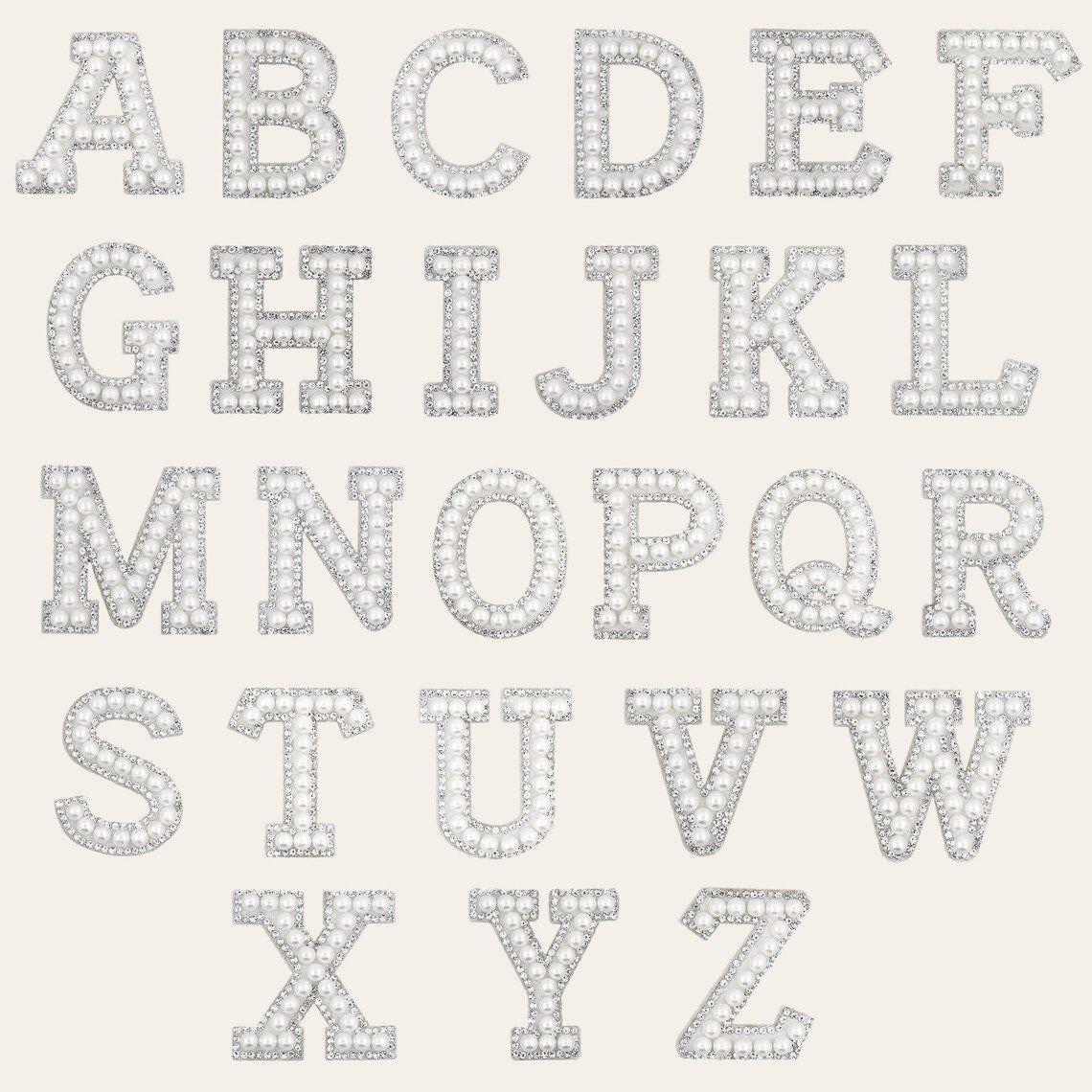 the alphabet letters of the English alphabet, each one made up of numerous small diamonds or gemstones, creating a sparkling and luxurious appearance.