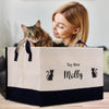 a woman holding a cat in a toy box