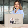A beige tote bag with a business card design, featuring a smiling woman in a business suit.