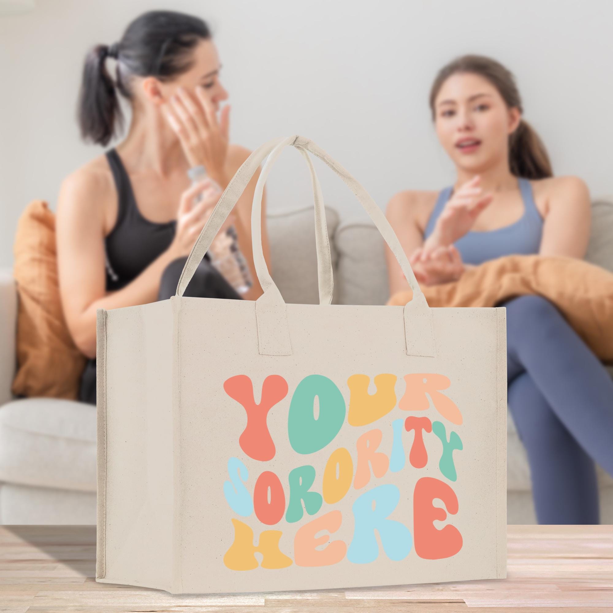 two women sitting on a couch with a shopping bag