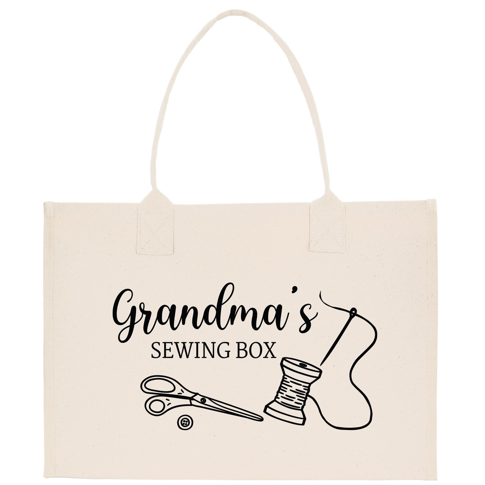 A beige tote bag with a printed design that says &quot;Grandma&#39;s Sewing Box&quot; and includes illustrations of sewing tools such as scissors and a spool of thread.