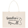 A beige tote bag with a printed design that says "Grandma's Sewing Box" and includes illustrations of sewing tools such as scissors and a spool of thread.
