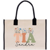 a tote bag with flowers and letters on it