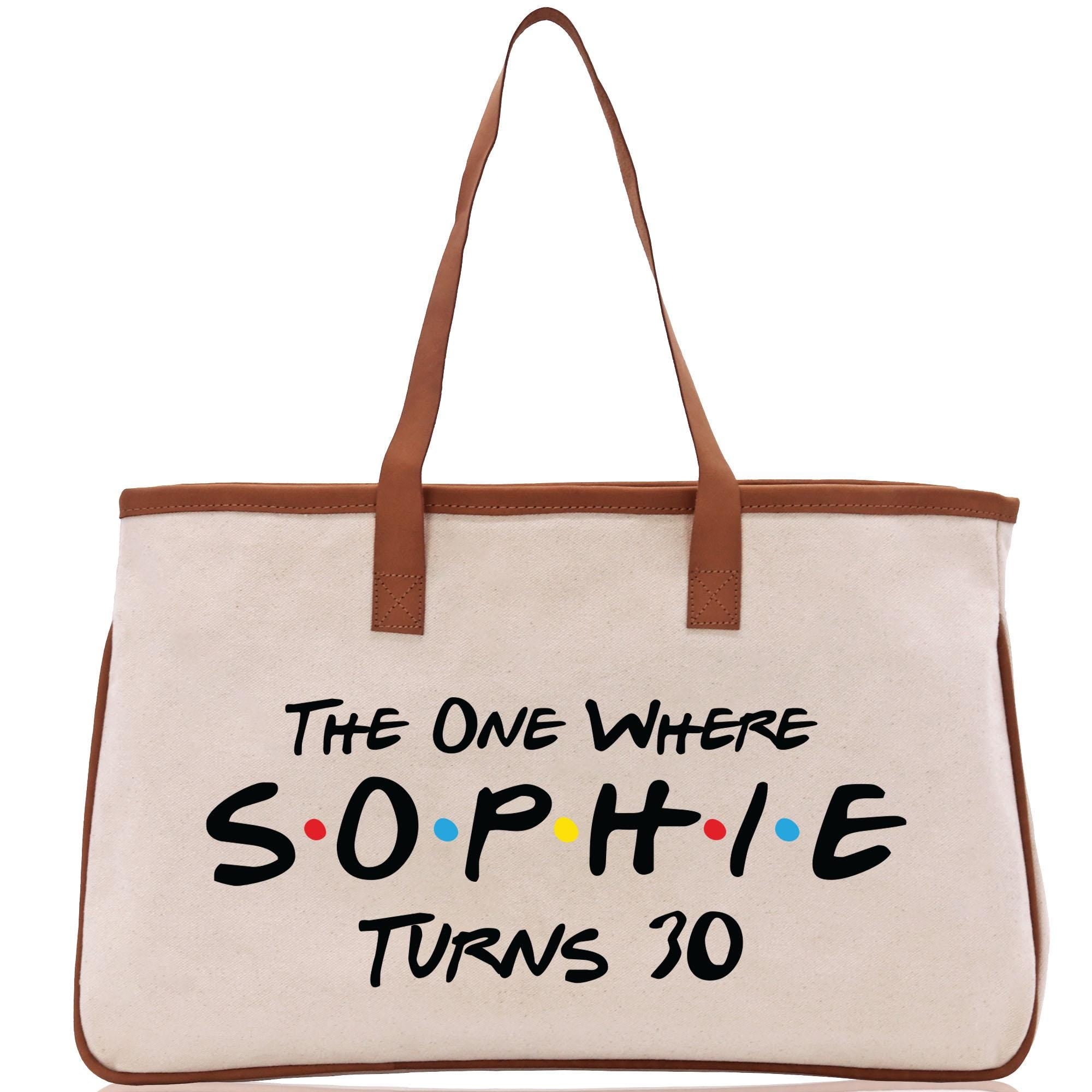 a white bag with a brown handle and the words the one where sophiie